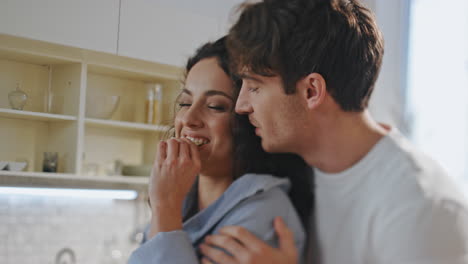 spouses enjoy cooking together standing kitchen closeup. romantic couple hugging