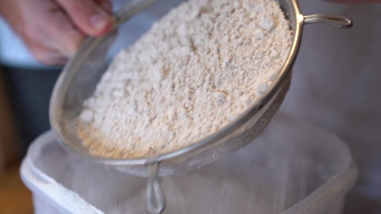 Sifting Freshly Milled Wheat Flour In Kitchen