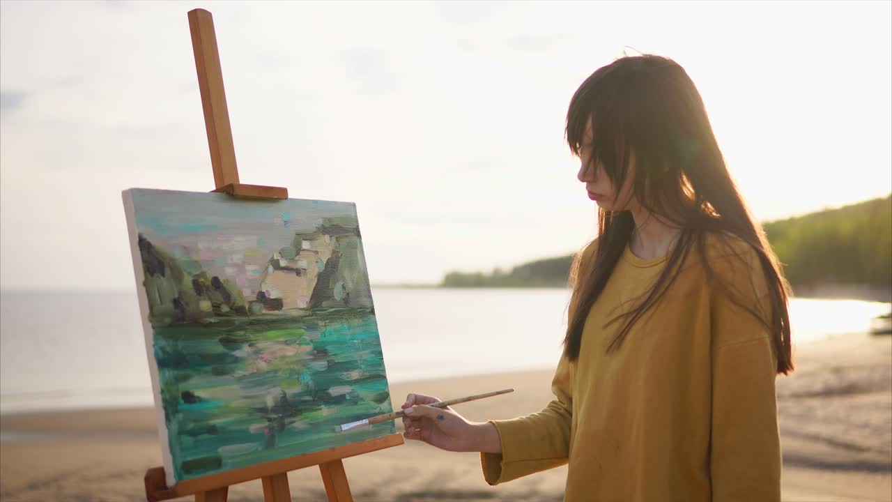 Woman Painting Seascape on the Beach at Sunset