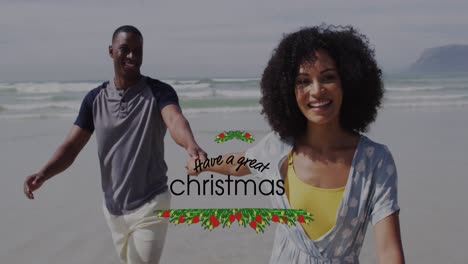 Animation-Von-„Ich-Wünsche-Ihnen-Ein-Tolles-Weihnachtsfest“-über-Ein-Glückliches-Afroamerikanisches-Paar,-Das-Am-Strand-Spaziert