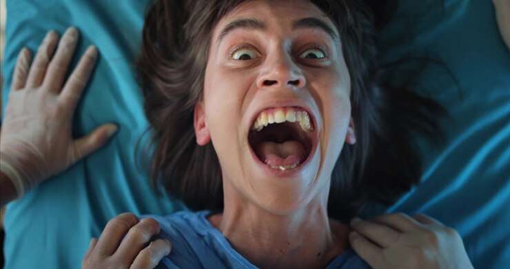 Young Woman's Intense Scream Transforms into a Manic Smile