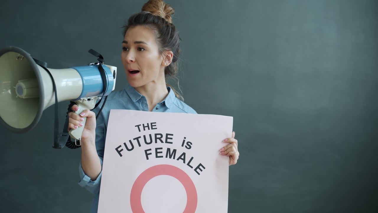 Woman Holding a Megaphone and Poster with Feminist Message