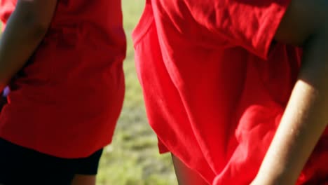 girl tying her shoe laces during training in the boot camp