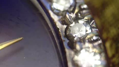 sparkling diamond jewels adorn watch casing. detail close-up slide