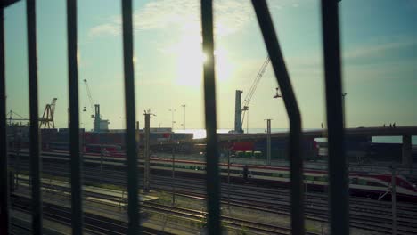 Harbor-sunrise-Lisbon-dawn-with-cranes-and-railway-through-rusty-fences