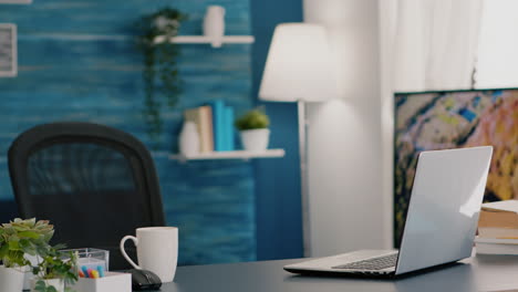 empty workplace home office with modern design and laptop placed on desk.