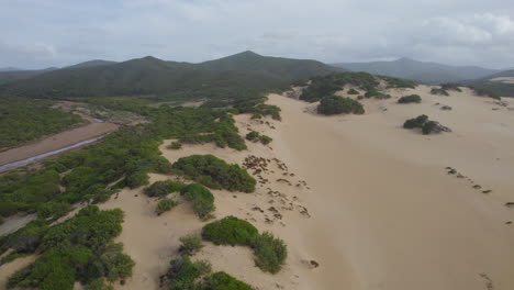 Spiaggia-di-Piscinas,-Sardinia:-flying-over-the-dunes-of-this-stunning-beach-on-the-island-of-Sardinia-on-a-sunny-day