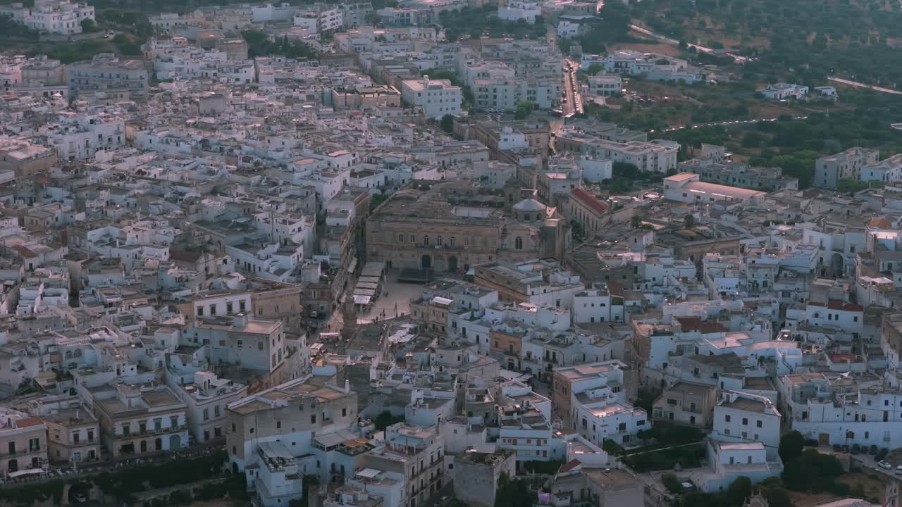 Ostuni's historic white buildings filling the landscape under the evening sky