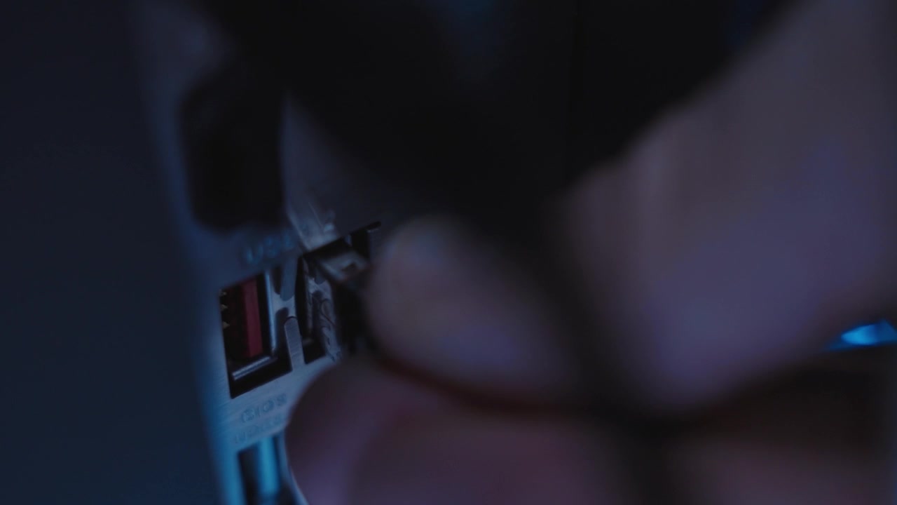 Extreme close up hand inserting thumb drive into desktop computer or server. Conspiracy stealing information and secret data or installing spyware by hacker or spy in government devices. Hidden tech