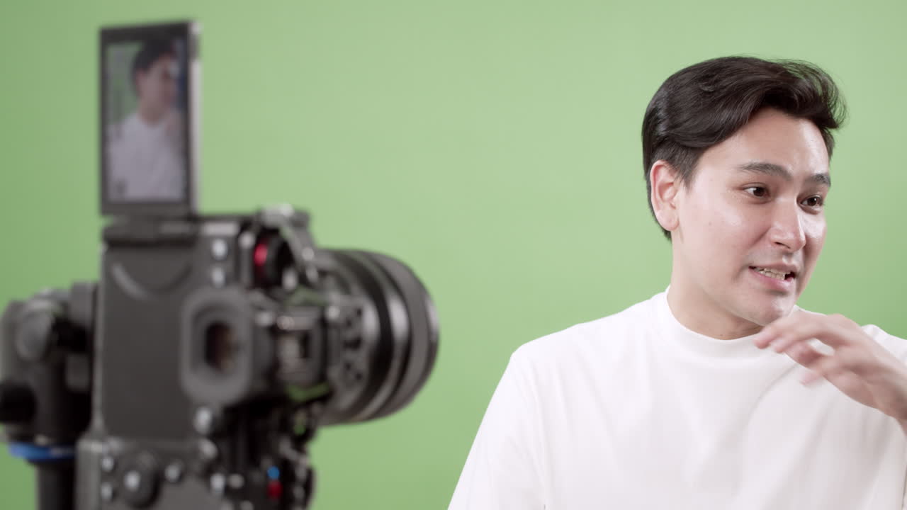 Man Vlogging in Front of Green Screen