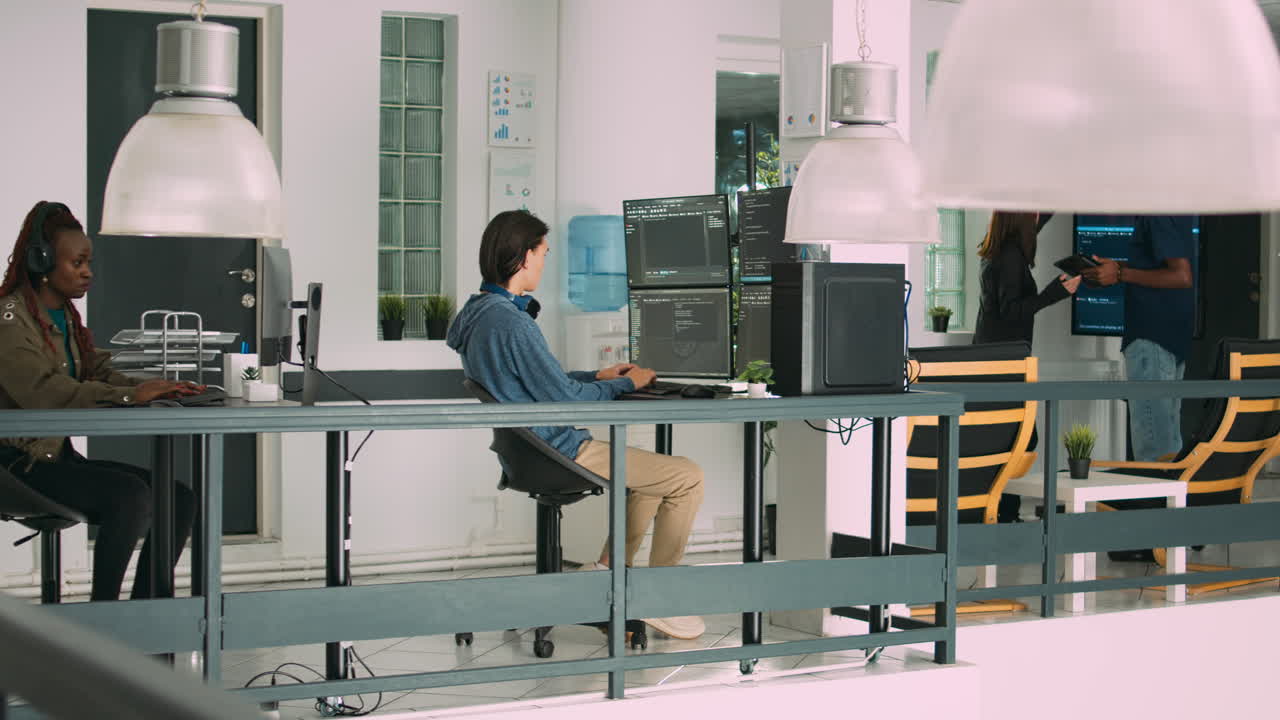 Senior developers coding on laptop in software agency office