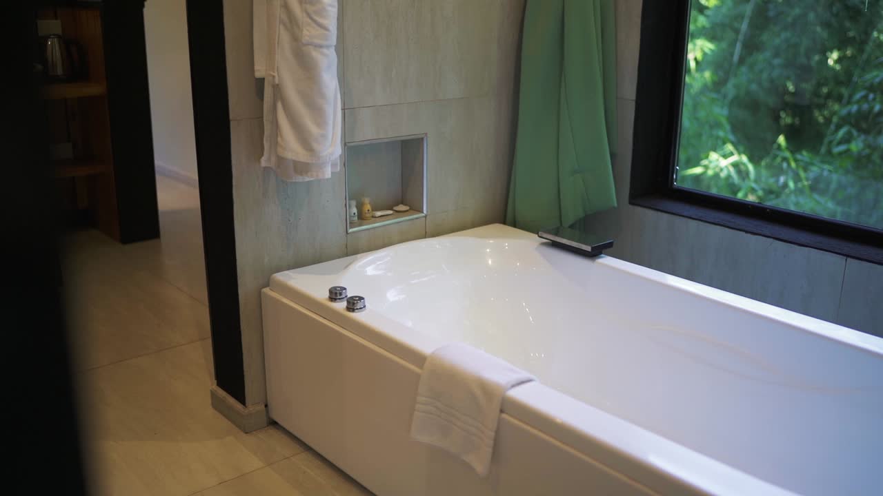 Minimalist bathroom design with modern bathtub with natural light in luxury hotel.