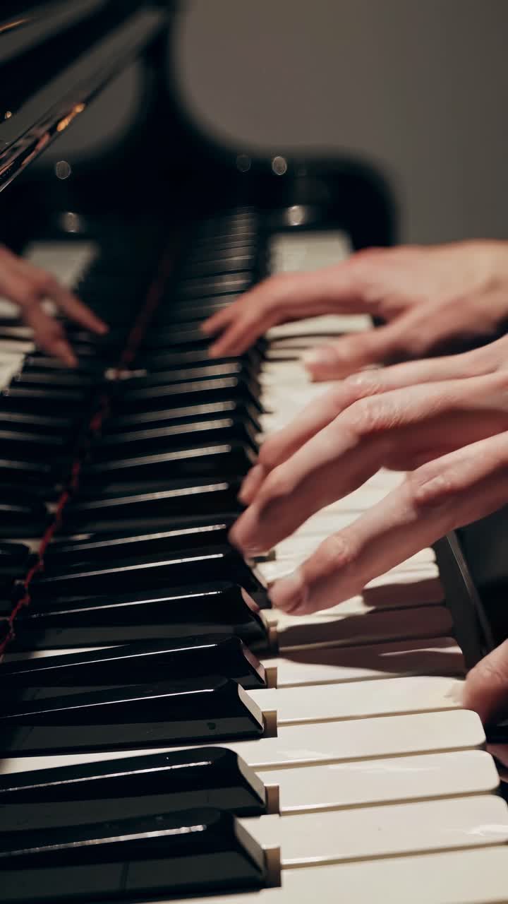 Close-up video of hands playing a piano, capturing the elegance and emotion of music