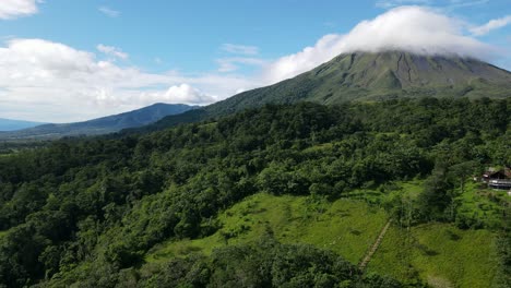 aerial view moving right shot, scenic view of lenticular clouds on arena volcano in costa rica, on a bright sunny day