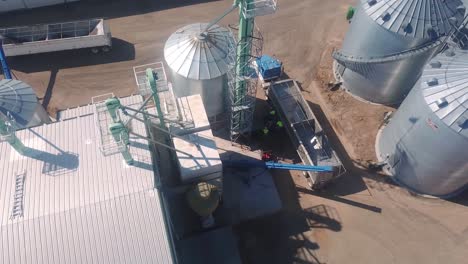 drone aerial view of a trailer being loaded at an agribusiness that exports cover seeds located in nebraska usa