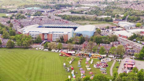 aerial shot flying over hillsborough football stadium in rural english countryside