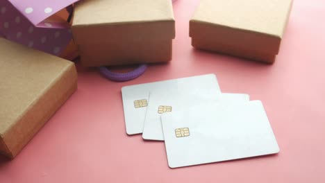 credit cards and gift box on pink background