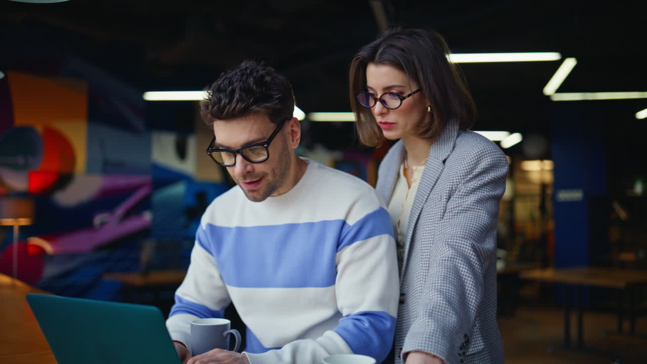 Art directors working laptop contemporary office closeup. Colleagues discussing