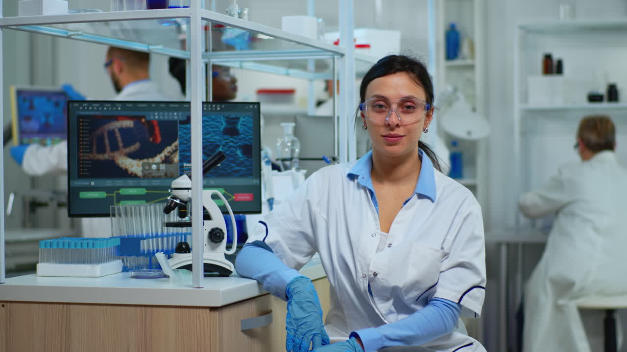 Tired laboratory doctor looking at camera smiling
