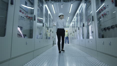 engineer walking through power station control room