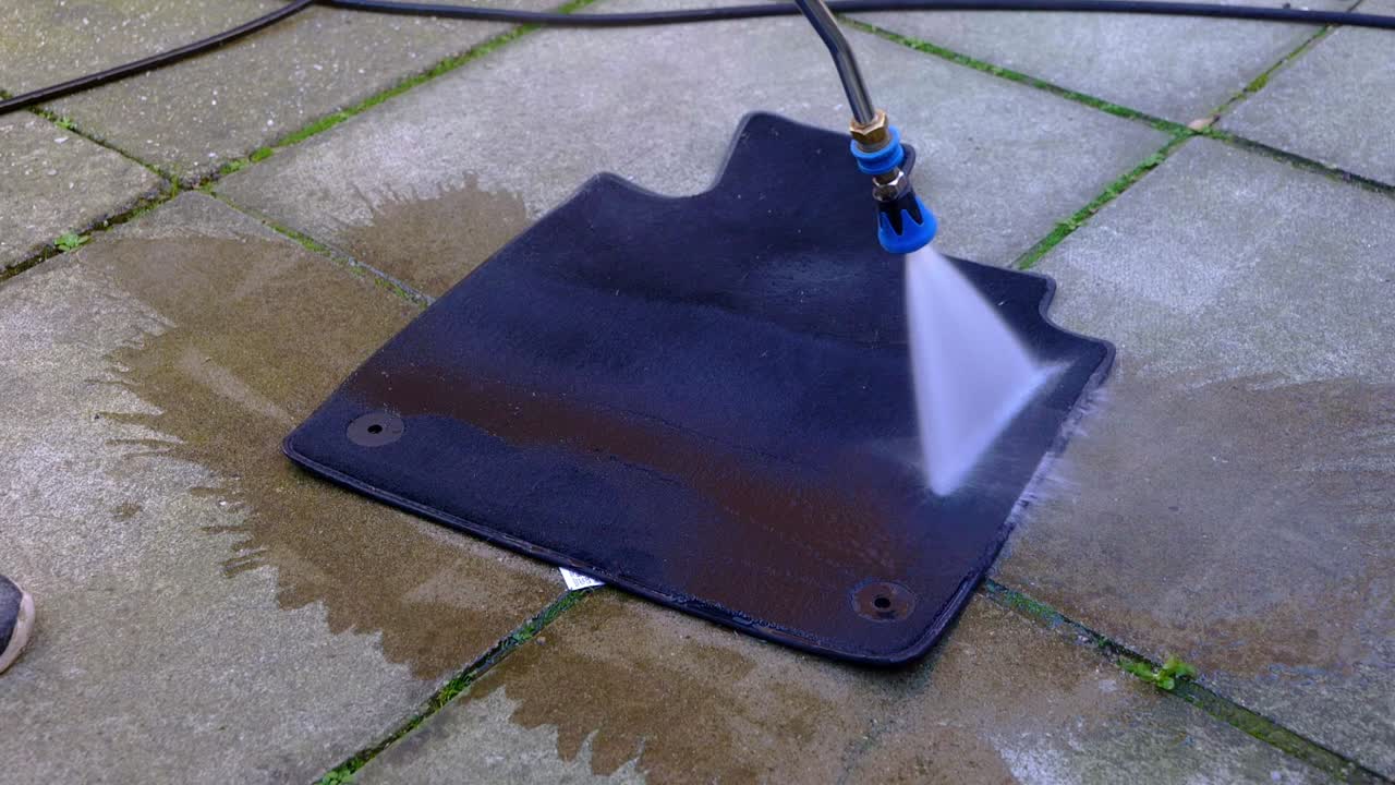 Pressure washing, rinsing, small car foot with blue nozzle jet wash - medium shot