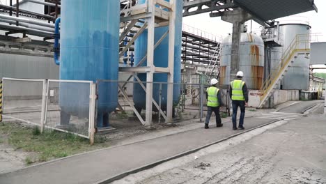 industrial workers inspecting equipment in a plant