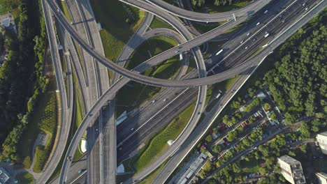 multi-level road interchange and cars traffic. drone is spinning around at high altitude. aerial vertical shot.