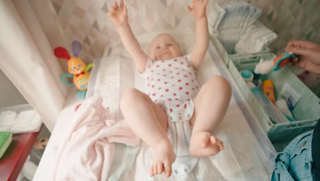 Baby-Playing-On-The-Changing-Mat