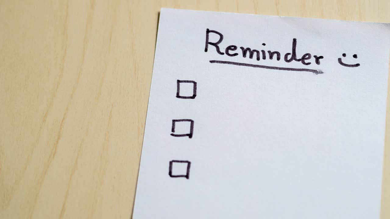 A close-up view of a reminder note a wooden desk symbolizing organization and productivity.