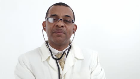 jamaican african-american man doctor in white lab coat in glasses, put  stethoscope on  and smile over white wall background isolated