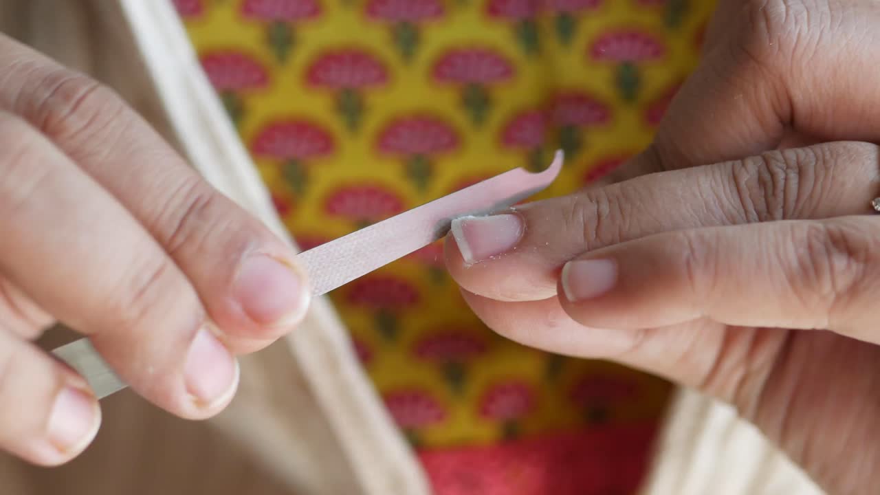 Woman filing her nails