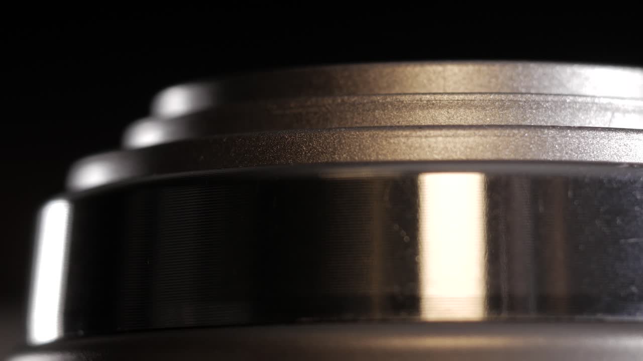 Top down macro of silver point and shoot zoom lens extending and retracting