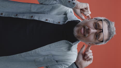 man with fingers in his ears blocking out sound