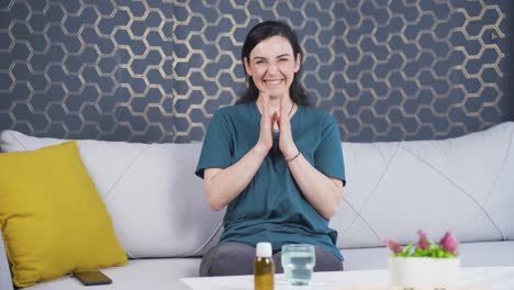 Woman-giving-congratulatory-message-to-camera-applauding.