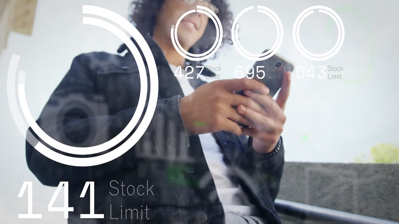 Animation of charts and icons moving over midsection of biracial man using smartphone