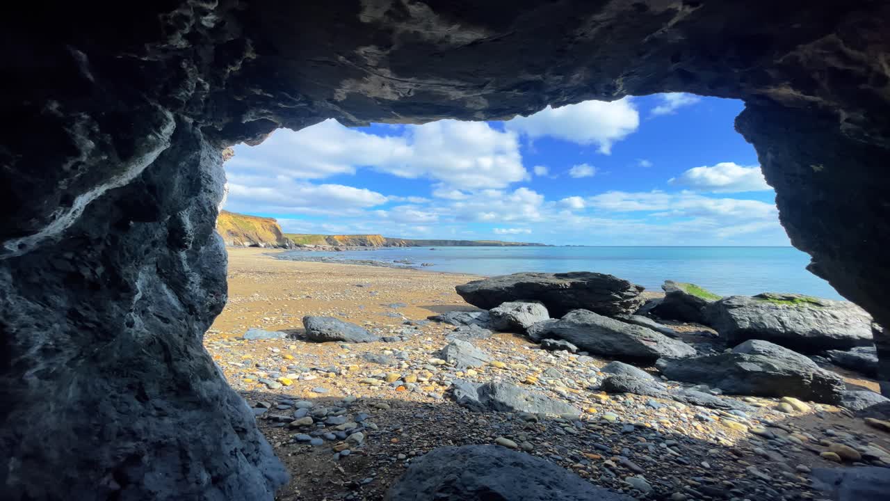 Ireland Timelapse Copper Coast Waterford view from sea cave on a bright spring day deserted beach epic location