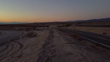 single car driving on freeway in salton sea desert california