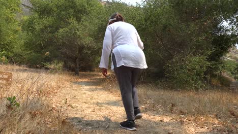 A-Blind-Woman-Walks-With-A-Cane-Through-A-Natural-Area-With-A-Guide-Helping-Her-Explore-The-Wilderness-3