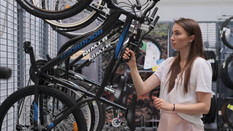 woman choosing a bicycle in a bike shop