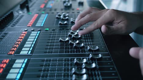 soundboard pads on tv station. sound designer used digital audio mixer in production studio. sound engineer moving sliders in radio station.engineer press key buttons on control desk recording studio.