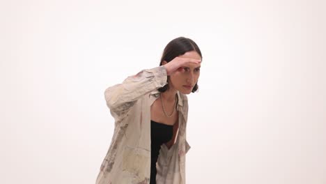a woman looking intently or shielding her eyes in a studio