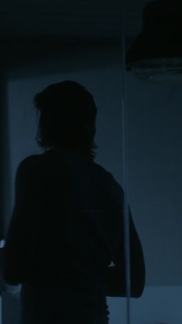 silhouette of a person in a dark room