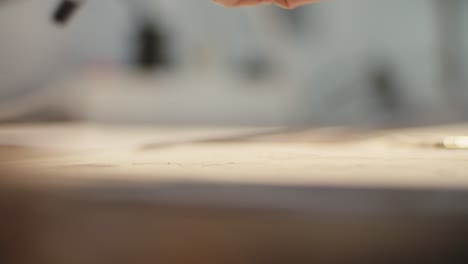 artist using a brush to paint on paper