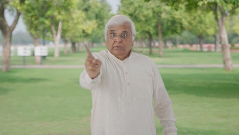 Angry-Indian-old-man-stopping-someone-in-park