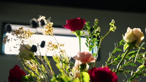 rotating close-up shot of vibrant florals with sunflare, creating a dreamy and romantic atmosphere. perfect for weddings or event decor in natural light.