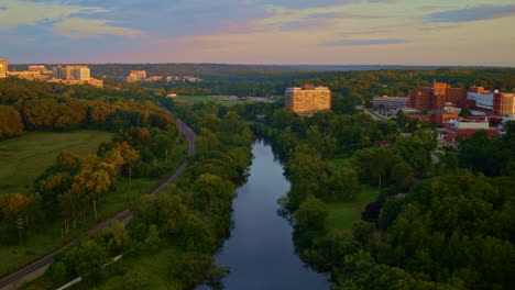 slow, gentle aerial drone footage of the huron river in ann arbor, michigan, in summer.