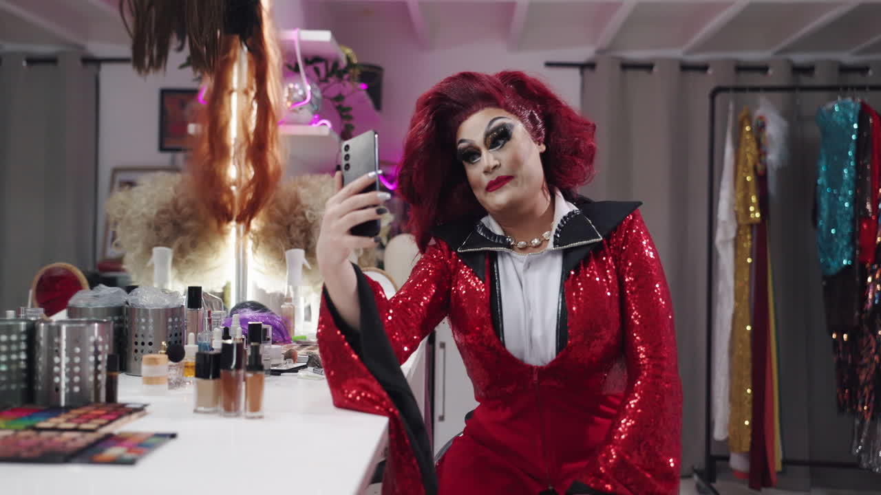 Drag queen taking a selfie in a dressing room