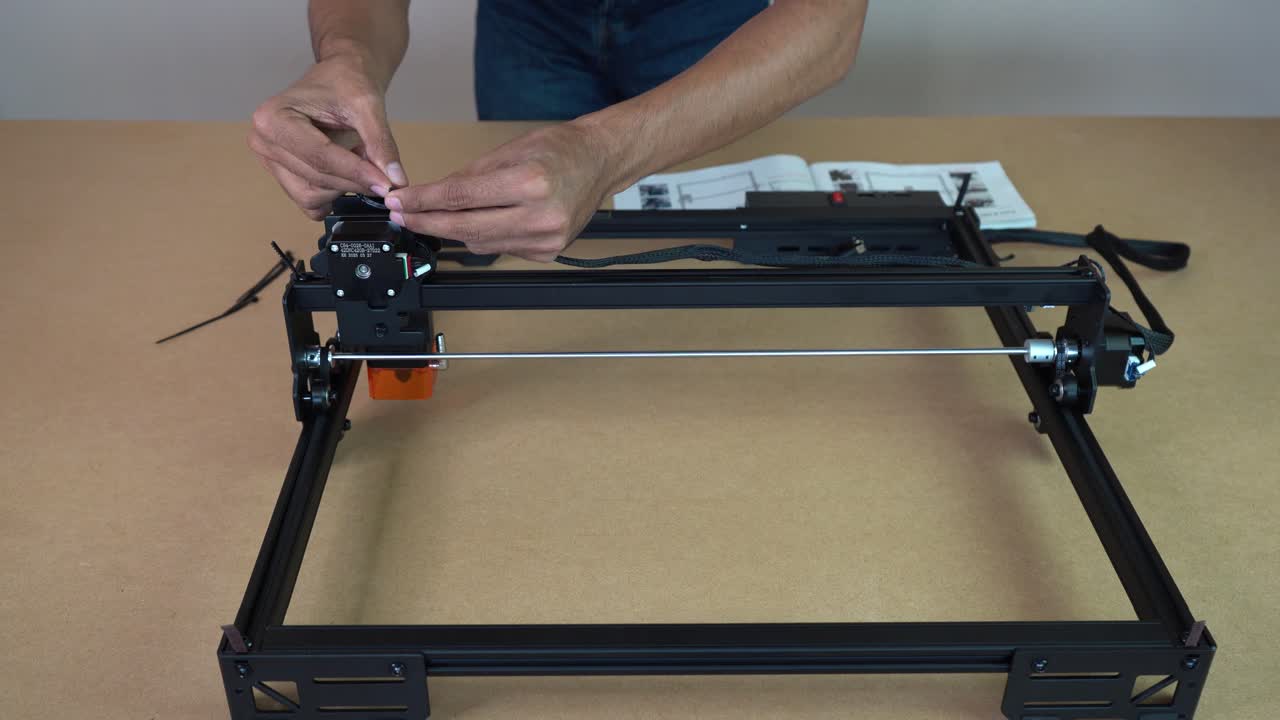 Man installing components during laser engraver setup
