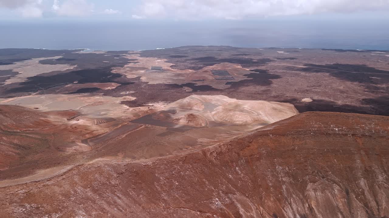 Impressive aerial drone footage of Caldera Blanca, the largest volcanic crater in Lanzarote measuring approximately 1,200 meters in diameter. Canary Islands, Spain.