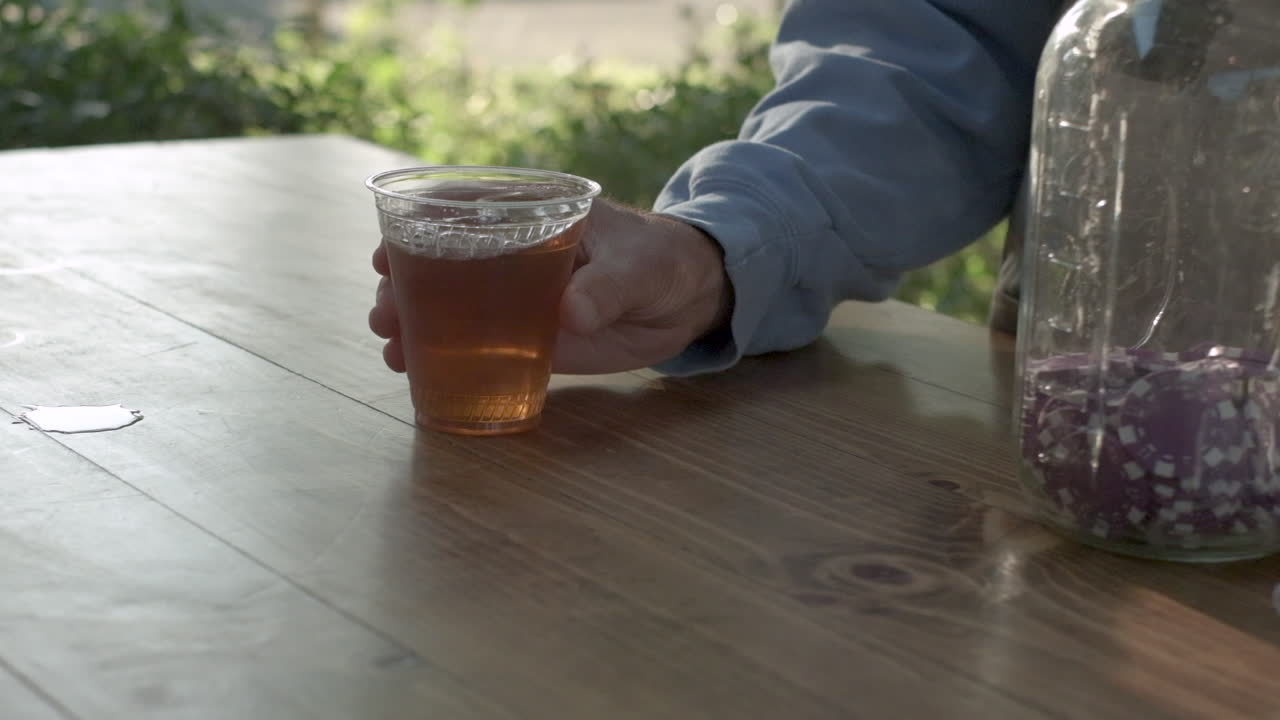 Person handing a cup of tea to another person